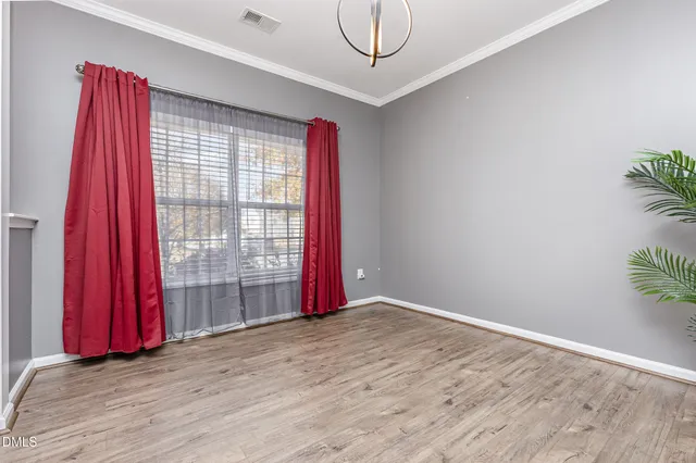 a view of a room with red walls and a window