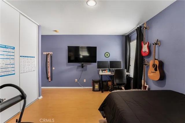 a bedroom with a bed and a flat screen tv