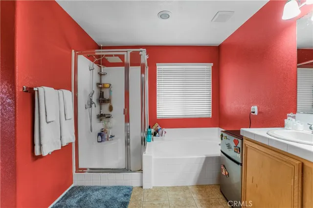 a bathroom with a bathtub a shower and a sink
