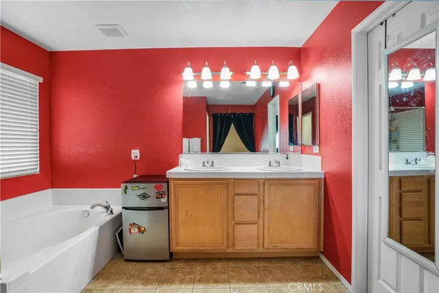 a bathroom with a tub sink and mirror