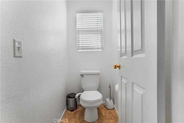 a white toilet sitting next to a window