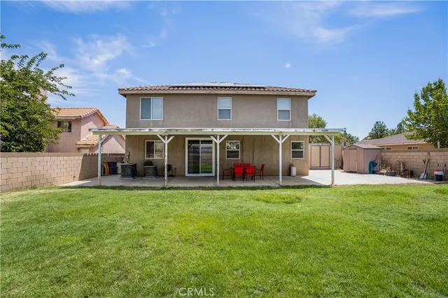 a view of a house with a yard and sitting area