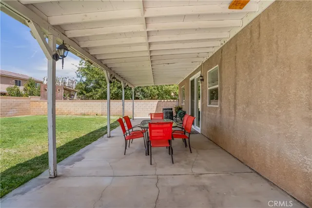 a backyard of a house with outdoor seating