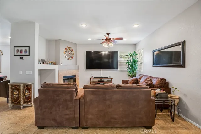 a living room with furniture a flat screen tv and a lamp