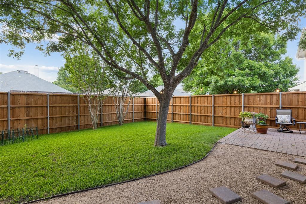 915 Rutgers Court Allen, TX 75002 - Photo 32 of 39 Looking across the yard of lush grass. The mature tree provides wonderful space. The fence was installed 2025.