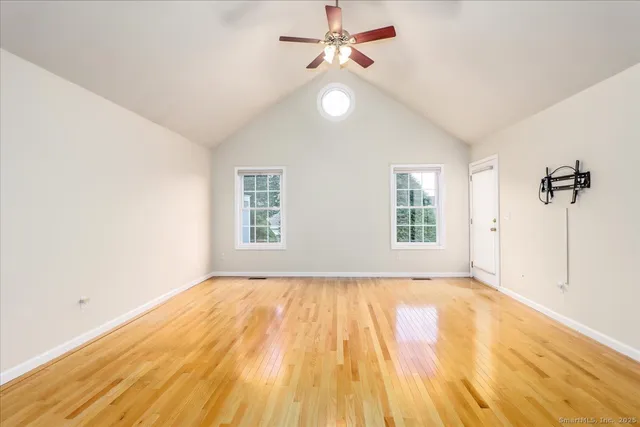 a dining room with furniture a chandelier and wooden floor
