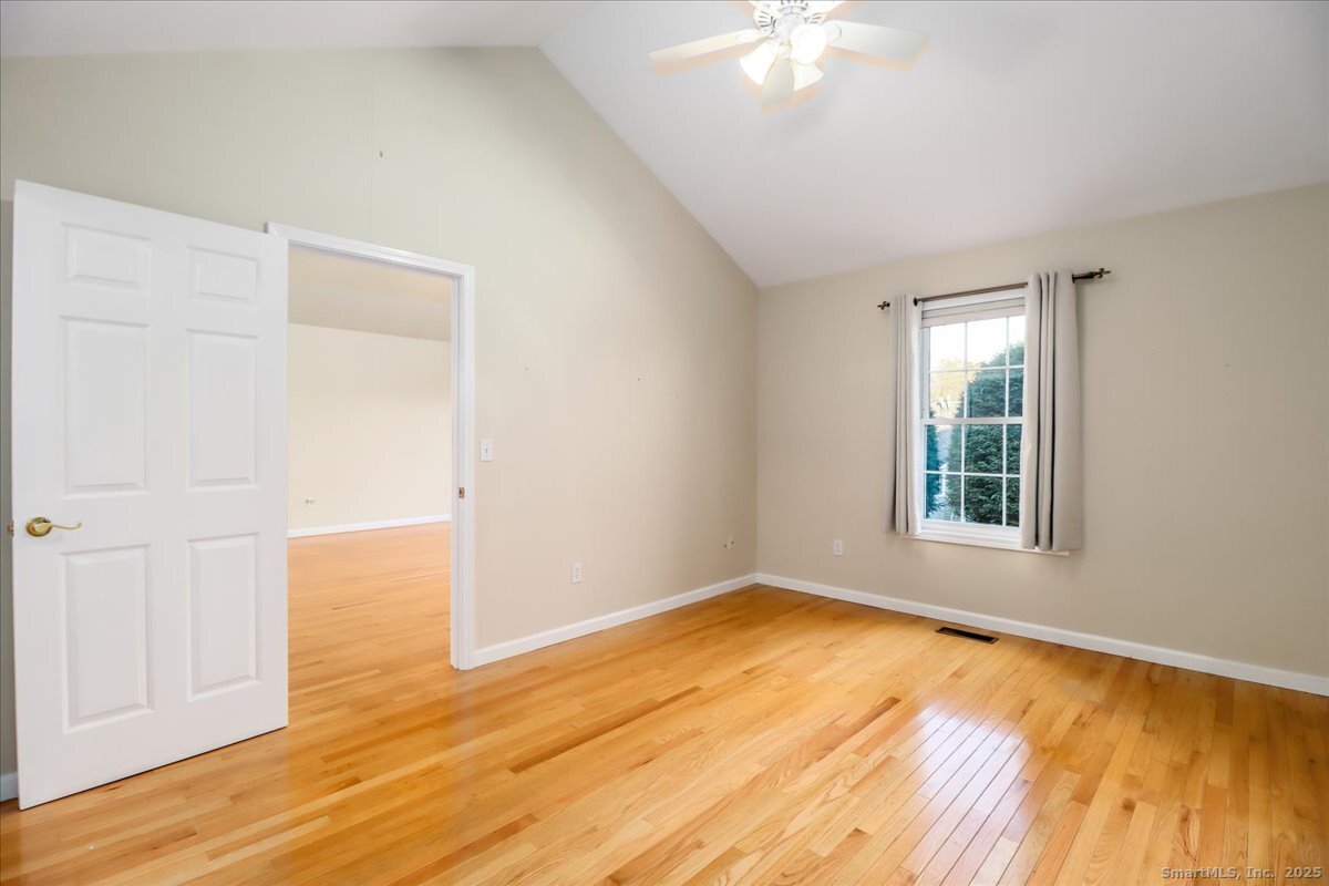 25 St George Place Newtown, CT 06482 - Photo 19 of 35 a view of an empty room with wooden floor and a window