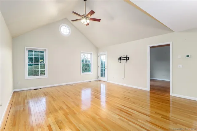 wooden floor in an empty room with a window