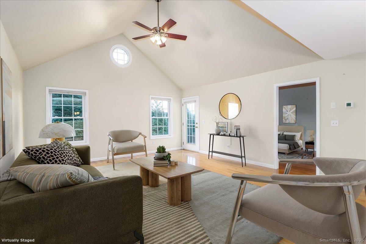 25 St George Place Newtown, CT 06482 - Photo 5 of 35 a living room with furniture a chandelier and a window