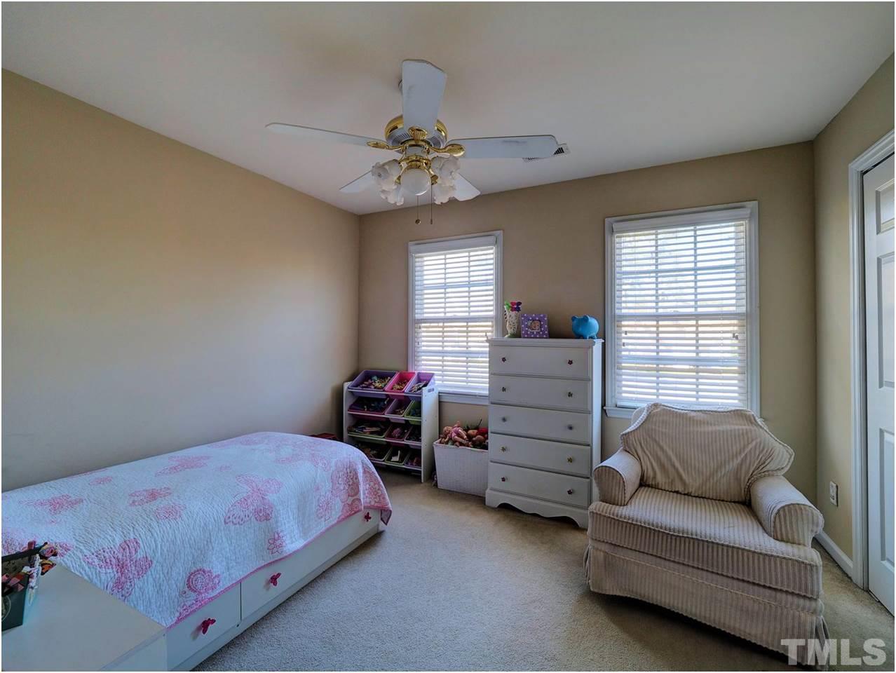 2312 Clerestory Place Raleigh, NC 27615 - Photo 16 of 25 a bedroom with a bed and furniture