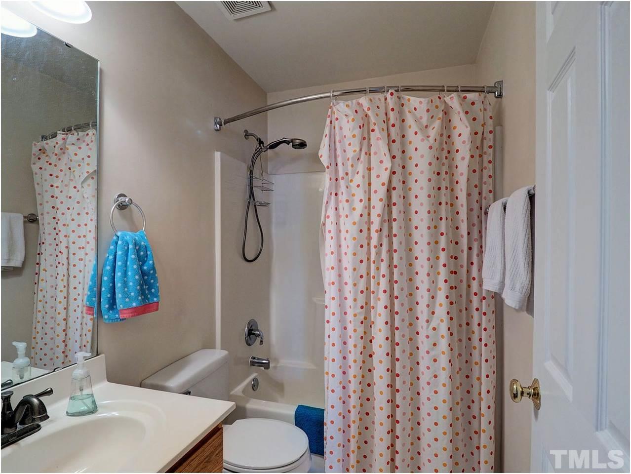 2312 Clerestory Place Raleigh, NC 27615 - Photo 17 of 25 a bathroom with a sink and a mirror