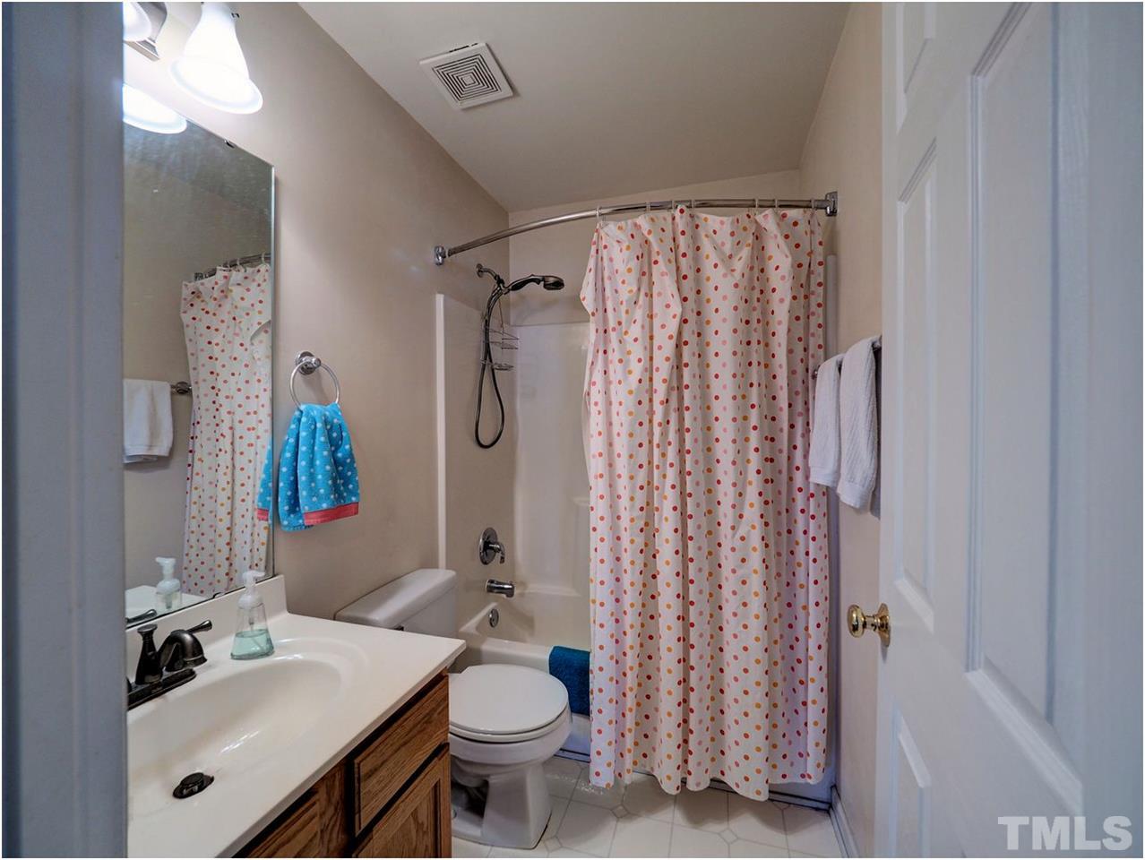 2312 Clerestory Place Raleigh, NC 27615 - Photo 18 of 25 a bathroom with a sink toilet and shower