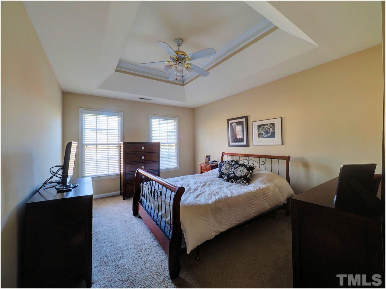 2312 Clerestory Place Raleigh, NC 27615 - Photo 20 of 25 a bedroom with a bed and wooden floor