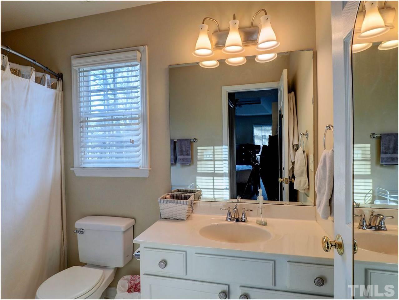2312 Clerestory Place Raleigh, NC 27615 - Photo 21 of 25 a bathroom with a sink vanity and a mirror