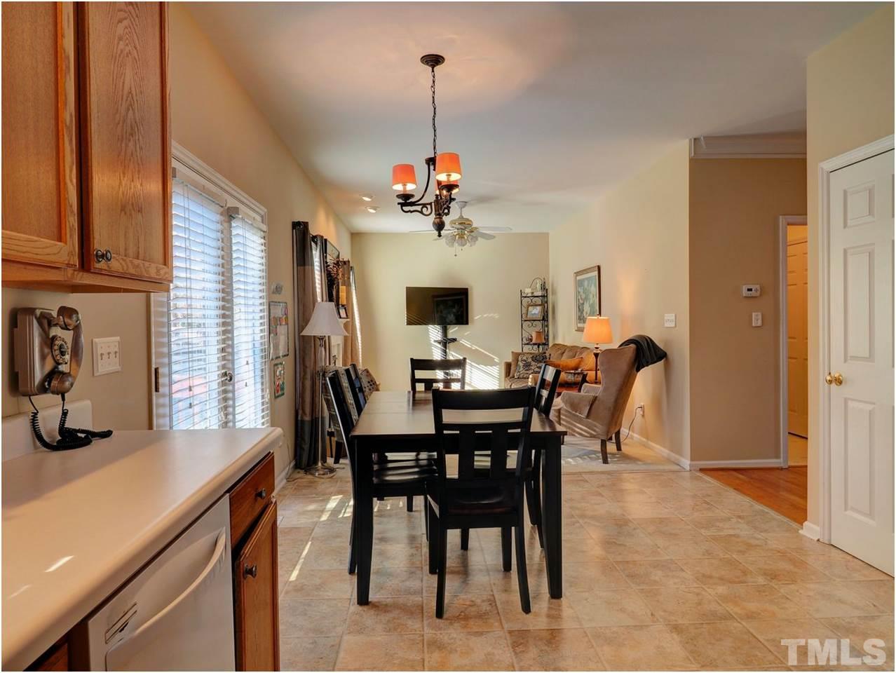 2312 Clerestory Place Raleigh, NC 27615 - Photo 7 of 25 a view of a dining room with furniture window and wooden floor