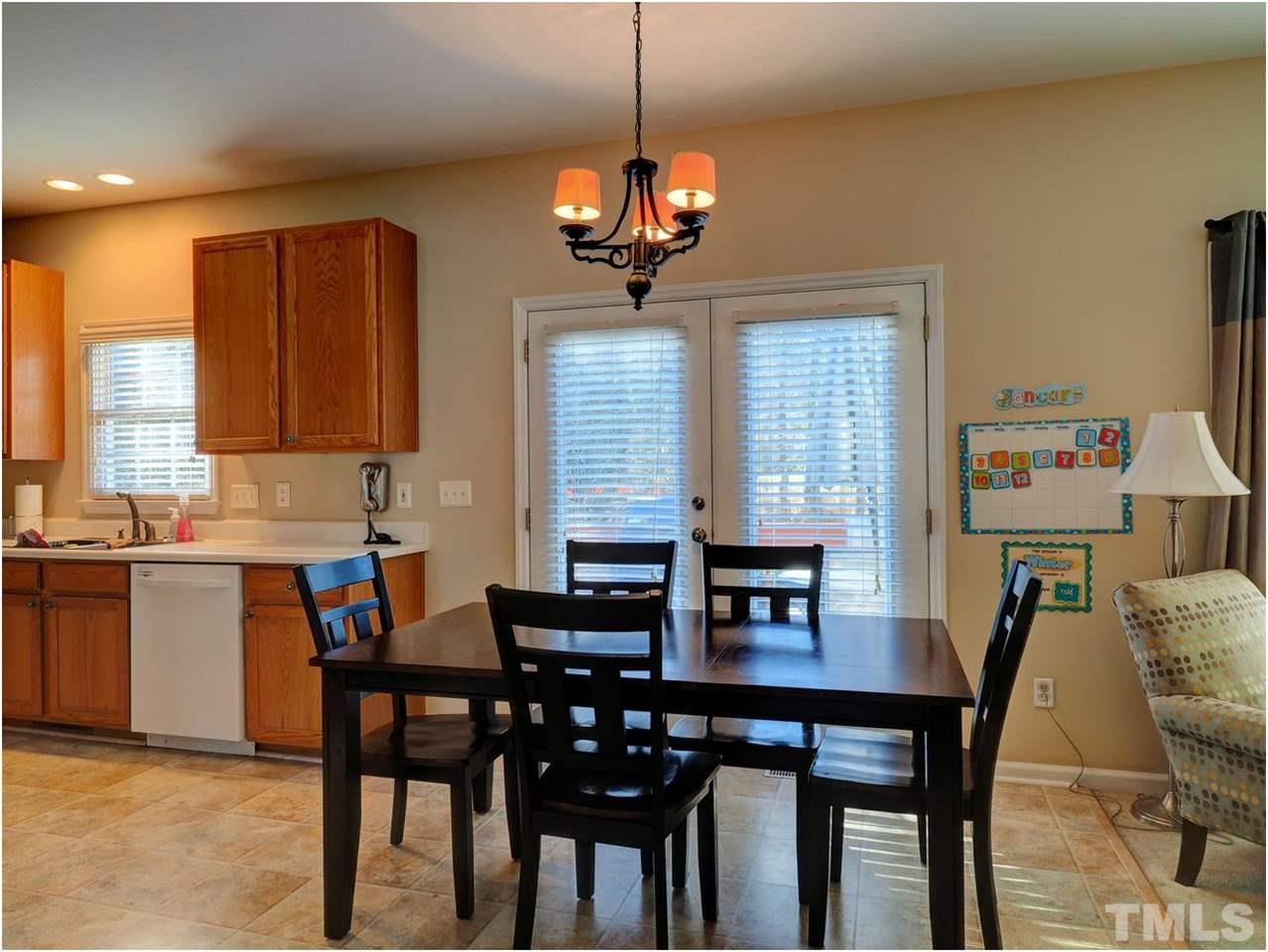 2312 Clerestory Place Raleigh, NC 27615 - Photo 8 of 25 a dining room with a wooden table and chairs
