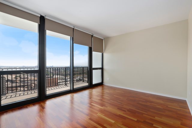 210 South Desplaines Street, Unit 2002 Chicago, IL 60661 - Photo 11 of 24 a view of an empty room with wooden floor