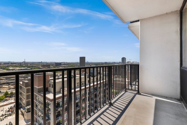 210 South Desplaines Street, Unit 2002 Chicago, IL 60661 - Photo 12 of 24 a balcony with wooden floor and city view