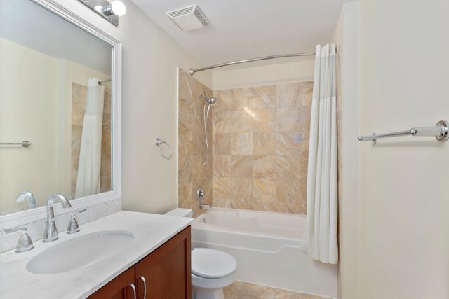 210 South Desplaines Street, Unit 2002 Chicago, IL 60661 - Photo 17 of 24 a bathroom with a granite countertop sink toilet and shower