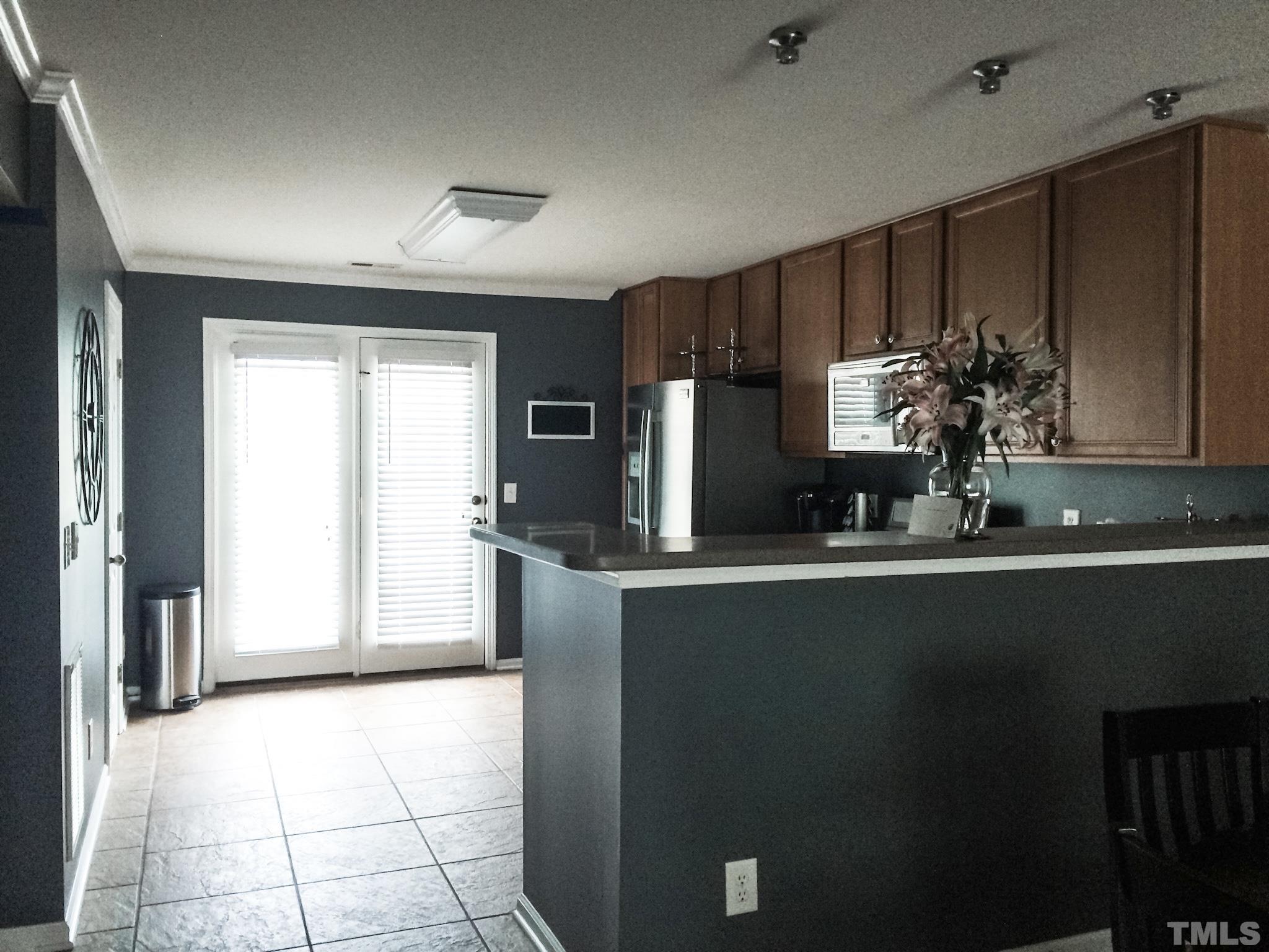 9906 Marni Court Raleigh, NC 27617 - Photo 7 of 11 a kitchen with stainless steel appliances a sink stove and refrigerator