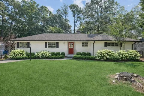 a front view of a house with a garden and porch