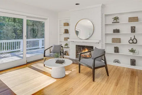 a living room with furniture a window and a fireplace