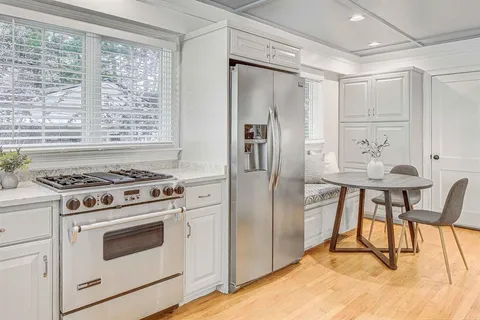 a kitchen with stainless steel appliances granite countertop a stove a refrigerator and a refrigerator