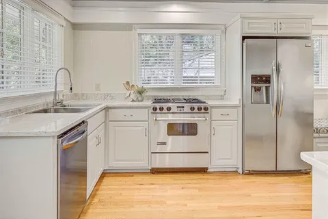 a kitchen with a stove oven and sink