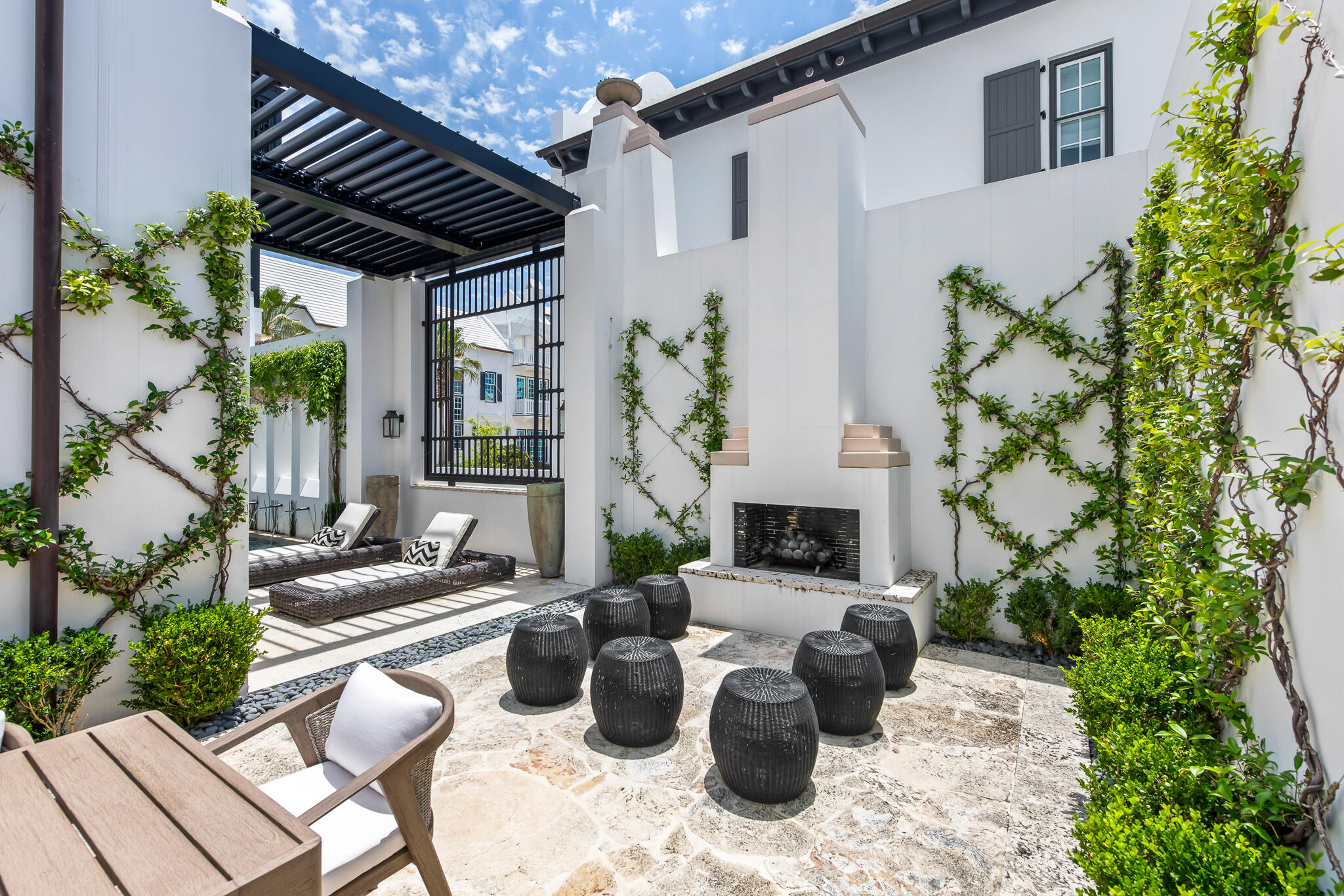25 Moongate Court Inlet Beach, FL 32461 - Photo 18 of 53 a view of a patio with couches table and chairs and potted plants