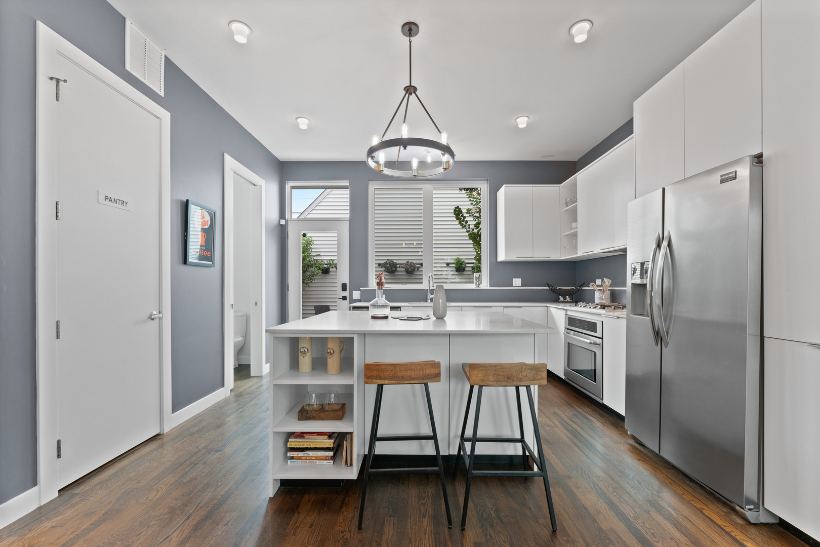3650 North Kenneth Avenue Chicago, IL 60641 - Photo 12 of 39 a kitchen with kitchen island a wooden floor and white appliances