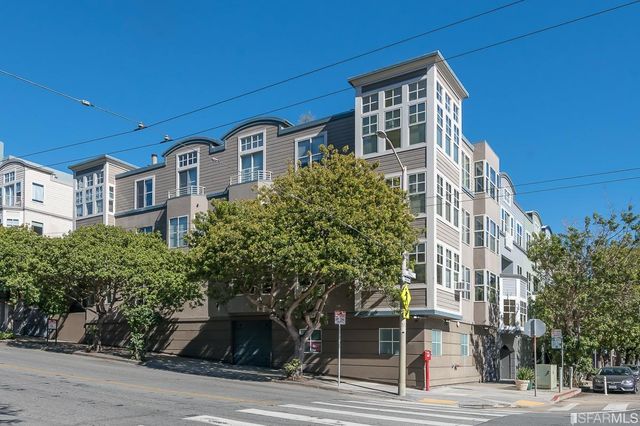 a living room with furniture wooden floor and a large window