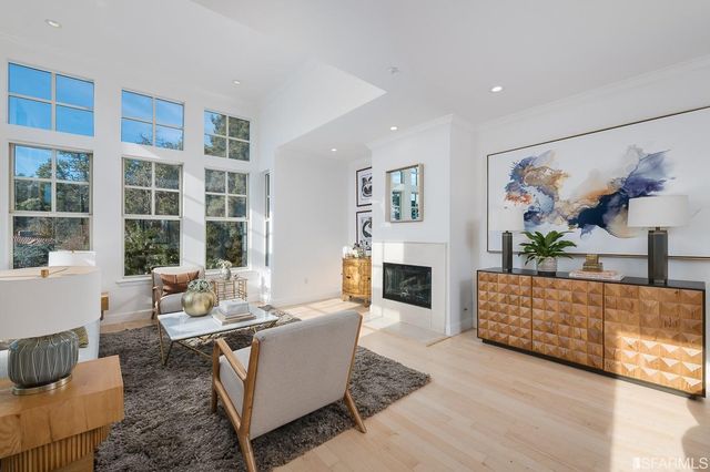 a kitchen with stainless steel appliances granite countertop a stove a sink dishwasher and a microwave oven with wooden cabinets