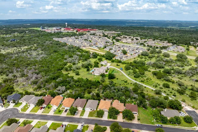 a view of a yard with wooden fence