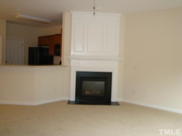 8330 Pilots View Drive Raleigh, NC 27617 - Photo 11 of 15 a living room with a fireplace and a flat screen tv