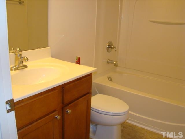 8330 Pilots View Drive Raleigh, NC 27617 - Photo 3 of 15 a bathroom with a toilet a sink and bathtub