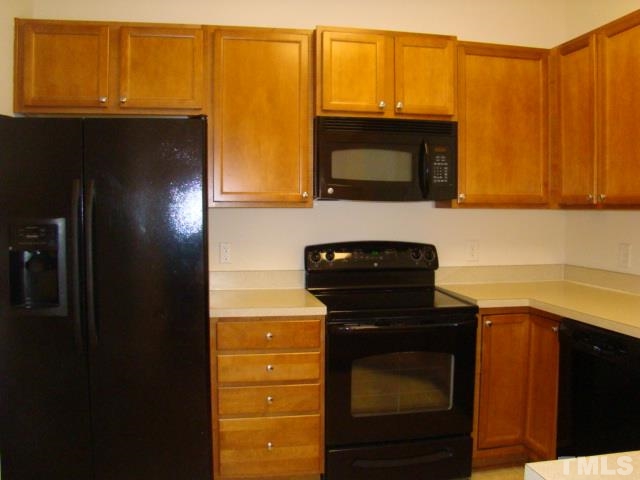 8330 Pilots View Drive Raleigh, NC 27617 - Photo 8 of 15 a kitchen with a stove and a microwave