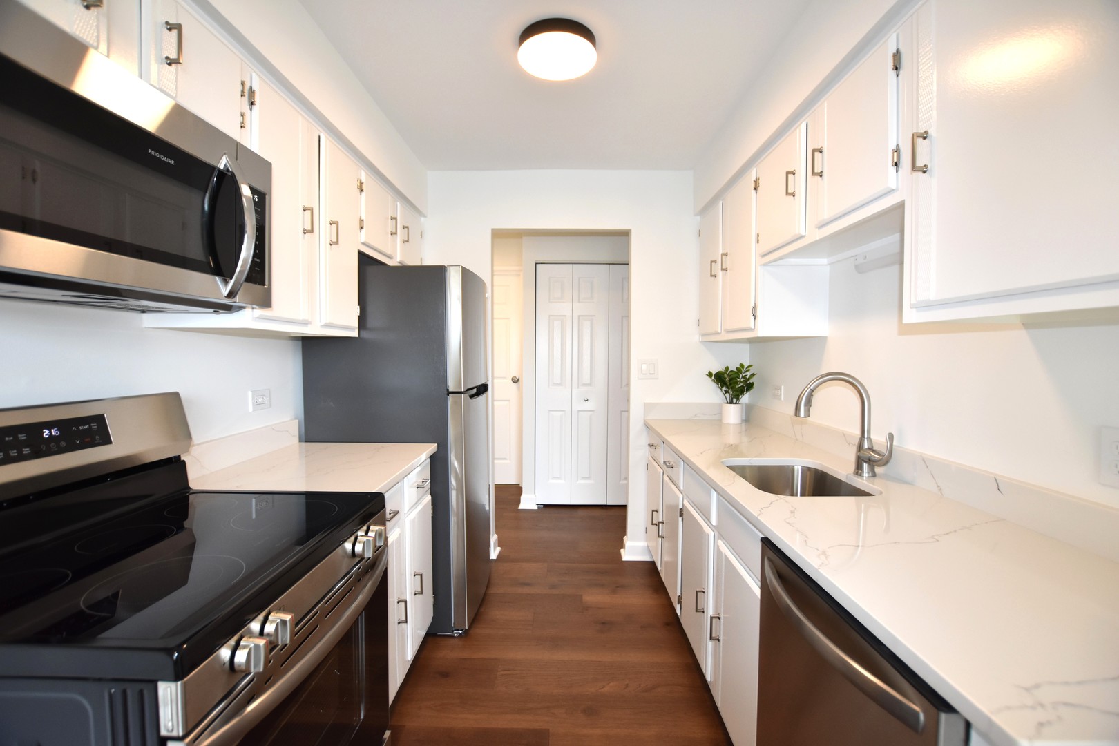 500 West Huntington Commons Road, Unit 157 Mount Prospect, IL 60056 - Photo 11 of 24 a kitchen with stainless steel appliances granite countertop a sink a stove and a refrigerator