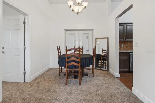 a kitchen with stainless steel appliances granite countertop a sink a stove top oven a refrigerator and a oven