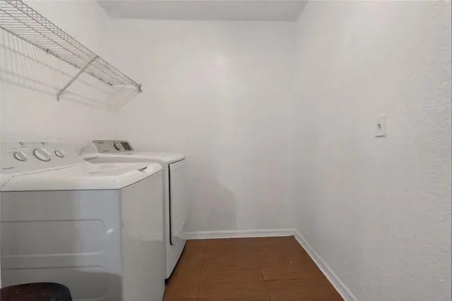 a bedroom with a bed and a chandelier fan