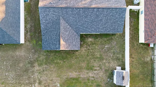 a living room with furniture a air conditioner and a flat screen tv
