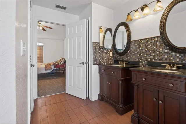 a living room with furniture a air conditioner and a flat screen tv