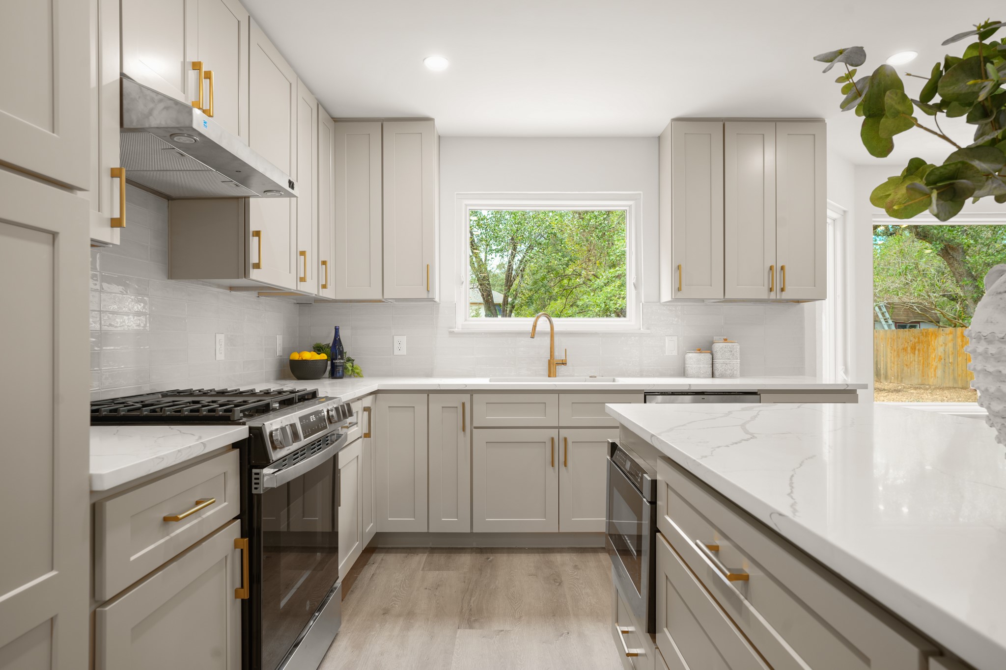 7826 Wheel Rim Circle Austin, TX 78749 - Photo 5 of 38 Streamlined cabinetry and sleek stone countertops define this modern cooking space.