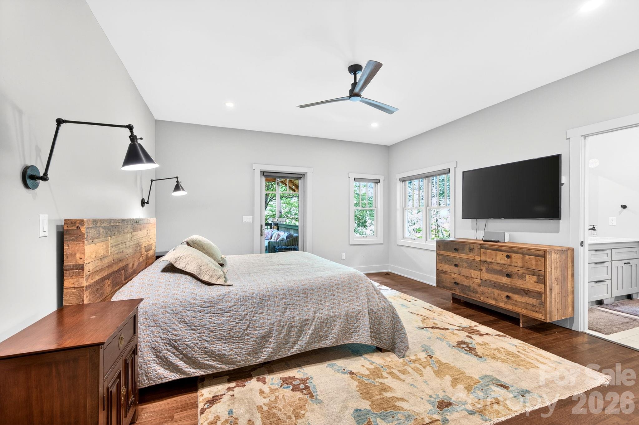 235 Bull Creek Road Asheville, NC 28805 - Photo 12 of 47 a bedroom with a bed and flat screen tv