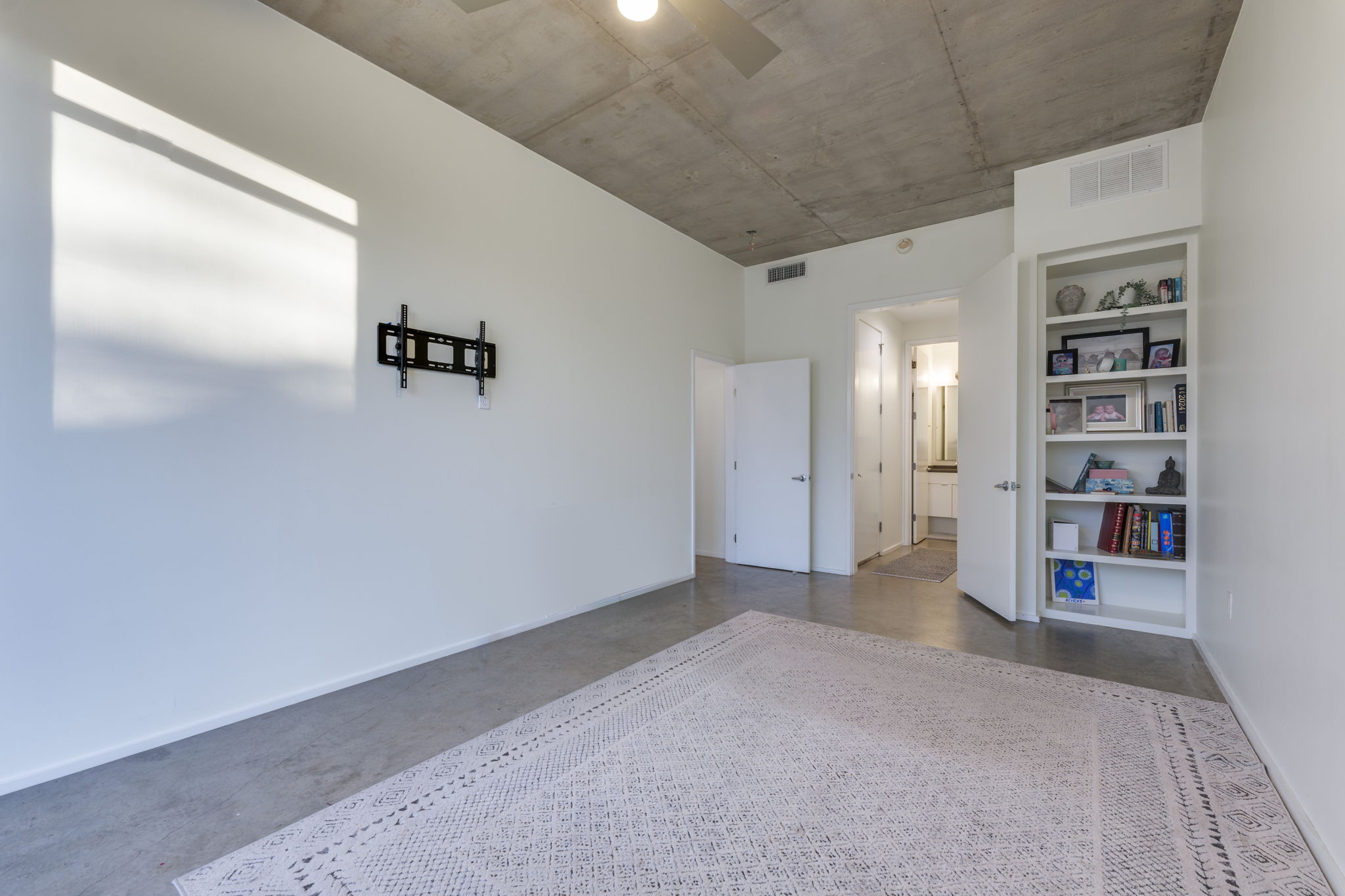 2301 South 5th Street, Unit 5 Austin, TX 78704 - Photo 6 of 39 1st floor guest room or office space zoned commercial with front exterior entry with built in bookshelf.