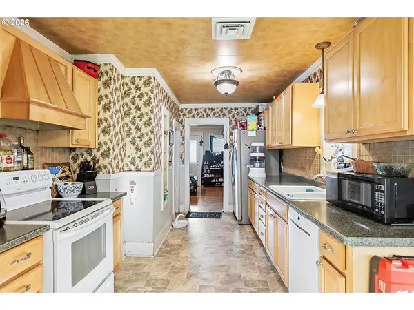 a kitchen with stainless steel appliances granite countertop a stove and a sink