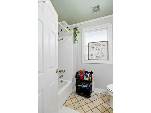 a view of a hallway with paintings on the wall