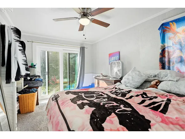 a bedroom with a bed and a flat tv screen