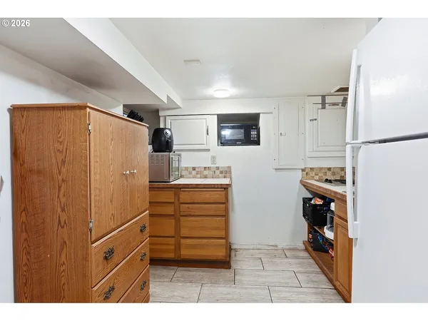 a kitchen with stainless steel appliances a refrigerator and a stove top oven