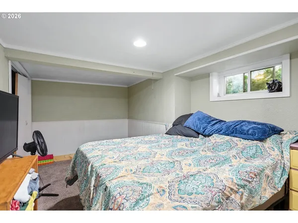 a bedroom with a bed and a window