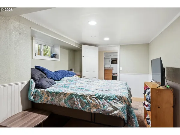 a bedroom with a bed and a television